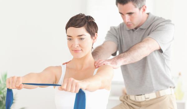therapist helping patient stretch